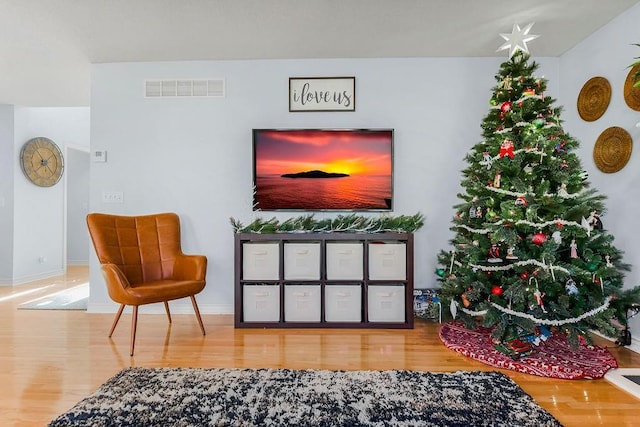 living area with hardwood / wood-style floors