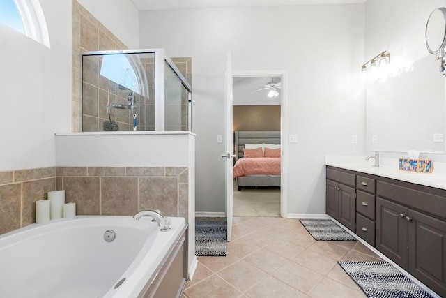 bathroom featuring tile patterned floors, separate shower and tub, vanity, and ceiling fan