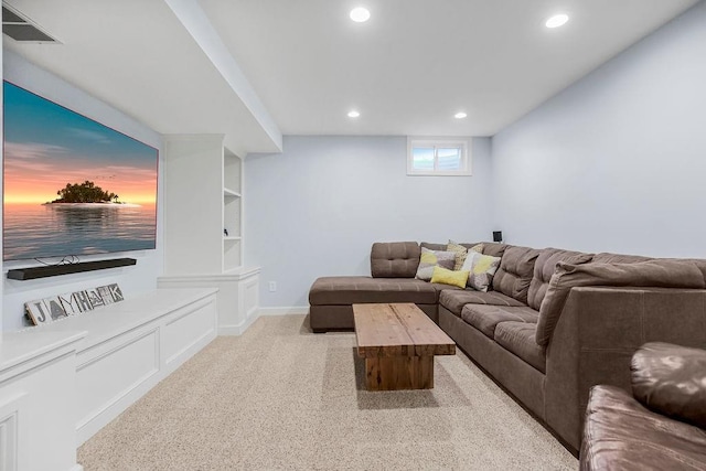 living room with built in shelves and light colored carpet