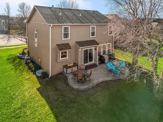 back of house featuring a lawn and a patio area