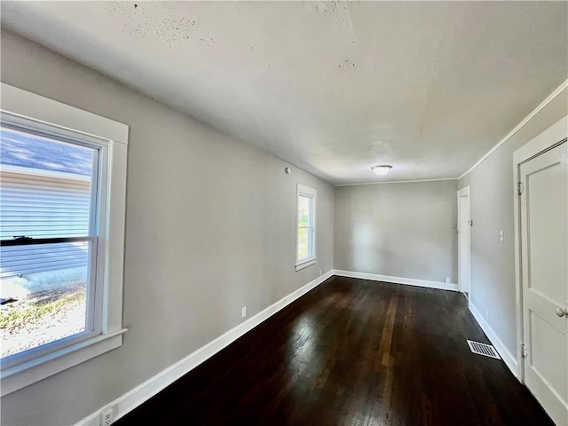 empty room with dark wood-type flooring