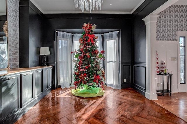 dining room with dark parquet floors, crown molding, a wealth of natural light, and an inviting chandelier