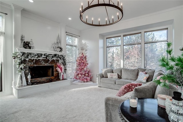 living room with a stone fireplace, crown molding, carpet floors, and a chandelier