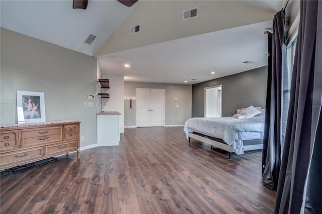 bedroom with ceiling fan, dark hardwood / wood-style floors, high vaulted ceiling, and a closet