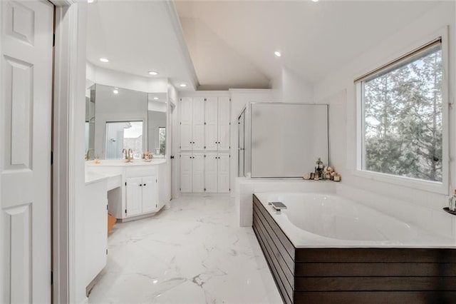 bathroom with separate shower and tub, vanity, and lofted ceiling