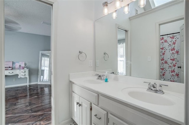 bathroom with a textured ceiling and vanity