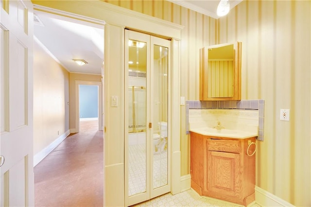 bathroom with french doors, vanity, and baseboards