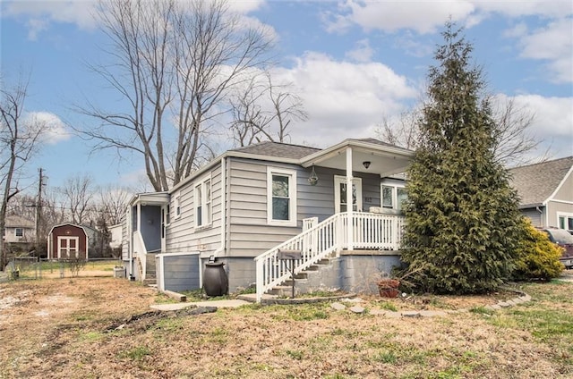 view of front of property with a storage shed