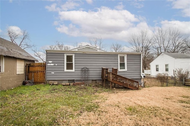 back of house with a lawn