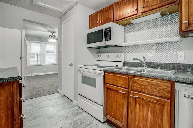 kitchen featuring a textured ceiling, white appliances, ceiling fan, and sink