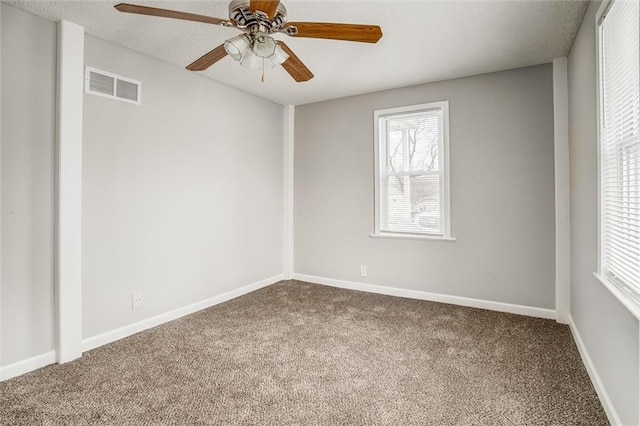 empty room with ceiling fan and carpet