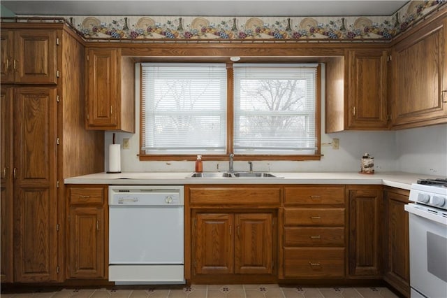 kitchen featuring white appliances, sink, and light tile patterned floors