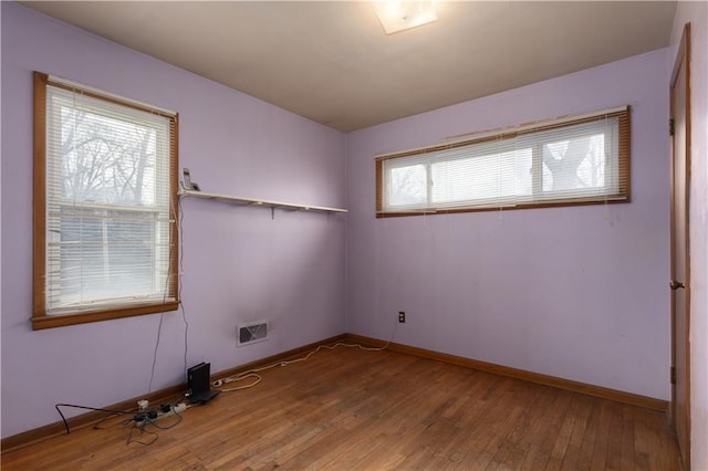 empty room with hardwood / wood-style floors