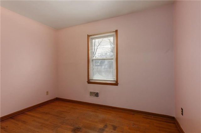 spare room with wood-type flooring