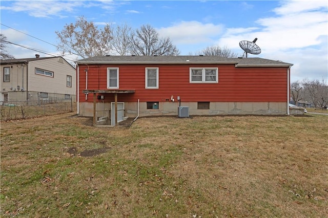 back of house featuring central air condition unit and a lawn