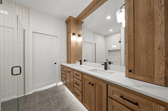 full bath featuring double vanity, a sink, and a shower stall