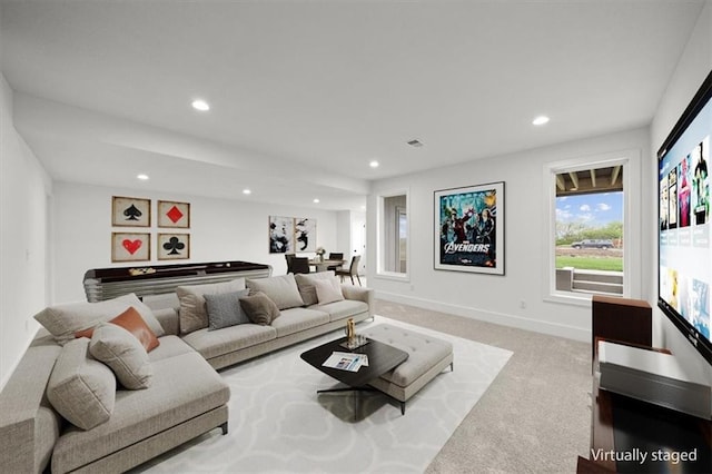 carpeted living room featuring baseboards and recessed lighting