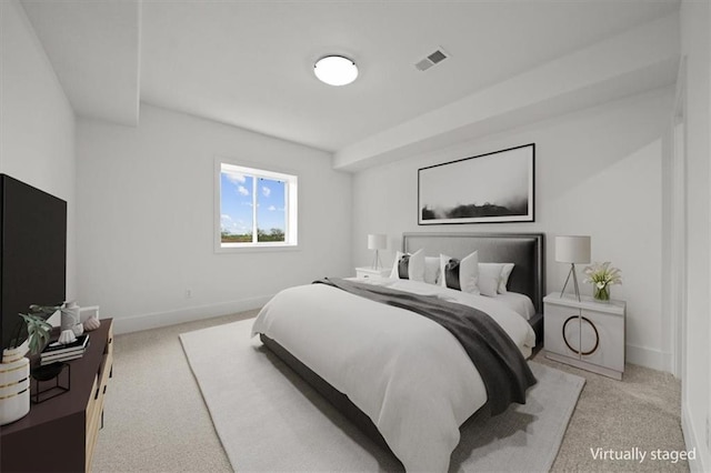 carpeted bedroom featuring baseboards and visible vents