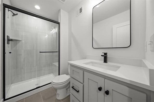 bathroom with vanity, tile patterned floors, toilet, and a shower stall