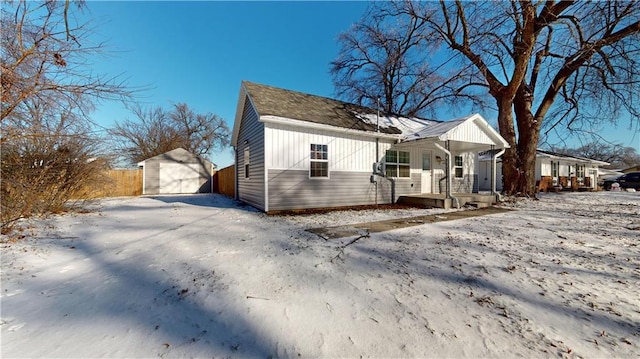 exterior space with a garage and an outbuilding