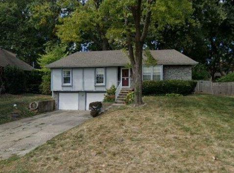 view of front of property featuring a garage and a front lawn