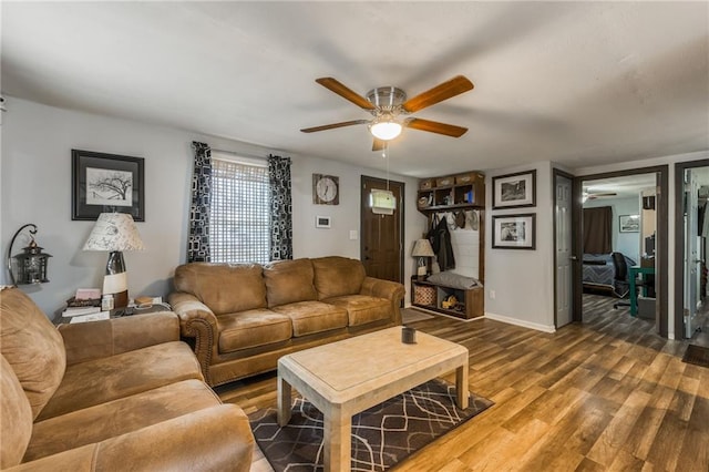 living room with ceiling fan and wood-type flooring