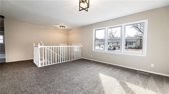 empty room featuring dark colored carpet