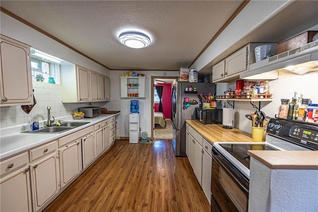 kitchen with backsplash, a textured ceiling, crown molding, wood-type flooring, and range with electric stovetop