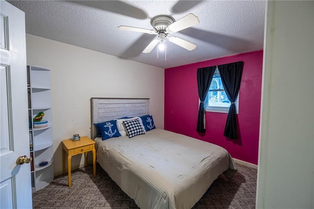 carpeted bedroom with ceiling fan and a textured ceiling