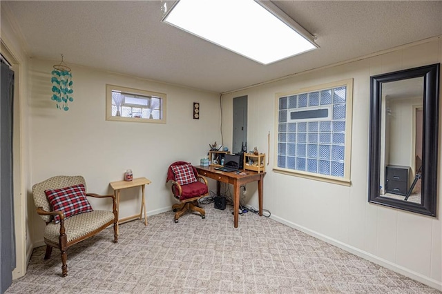 carpeted office featuring a textured ceiling and electric panel