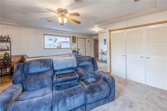 living room with ceiling fan and carpet floors