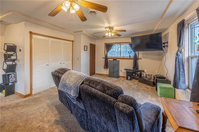 carpeted living room with ceiling fan