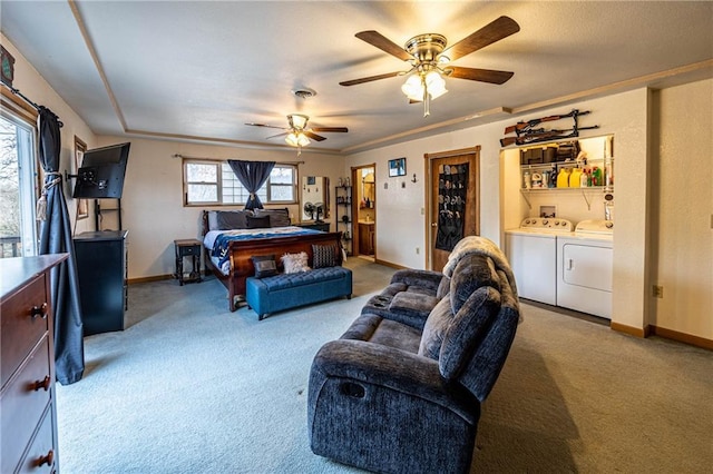 carpeted bedroom featuring independent washer and dryer and ceiling fan