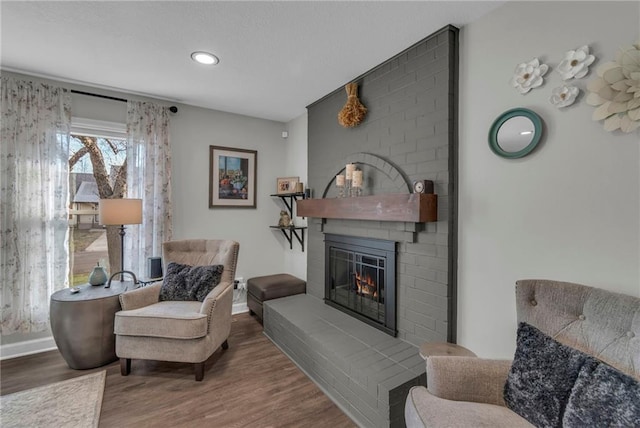 sitting room featuring hardwood / wood-style flooring and a fireplace