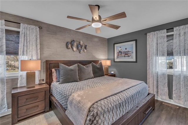 bedroom featuring ceiling fan and dark hardwood / wood-style flooring