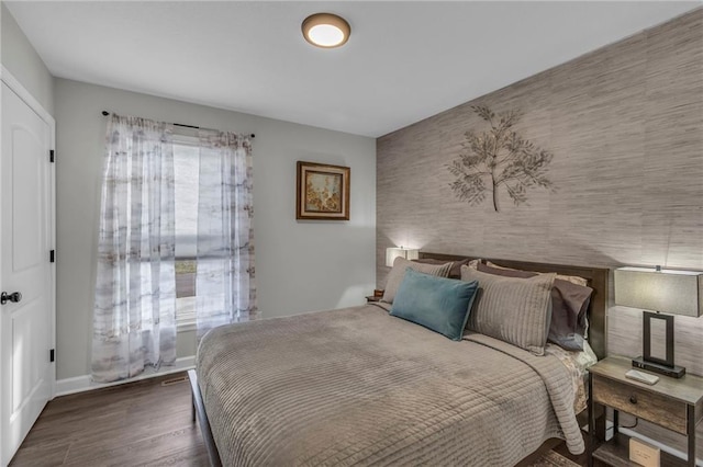 bedroom with dark hardwood / wood-style floors