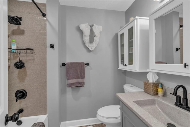 full bathroom with vanity, tiled shower / bath combo, and toilet