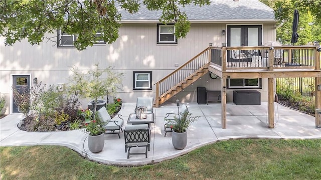 rear view of property with a patio area, a lawn, french doors, and a deck