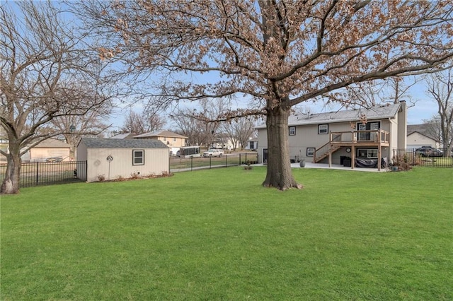 view of yard with a wooden deck and a storage shed