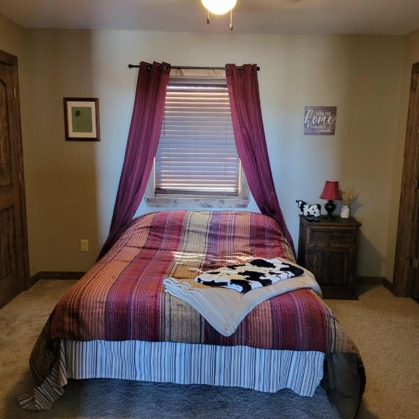 bedroom featuring light carpet