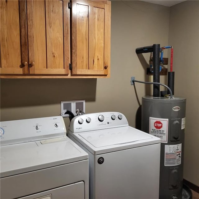 washroom with cabinets, electric water heater, and separate washer and dryer