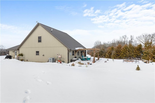 view of snowy exterior with central AC