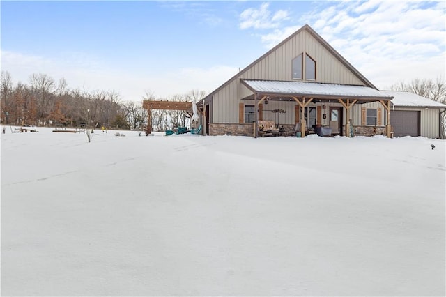 exterior space with covered porch and a garage