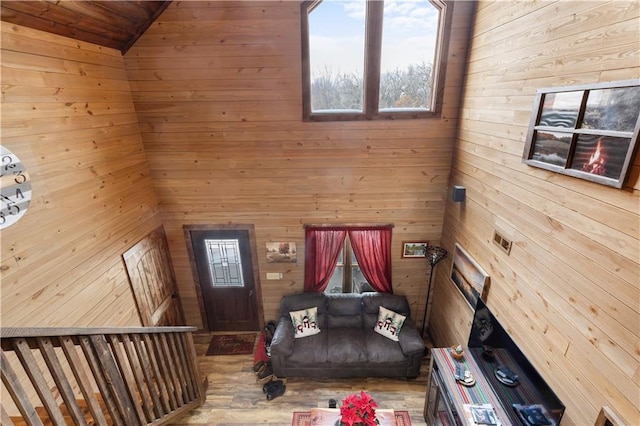 interior space featuring wood walls, wooden ceiling, and lofted ceiling