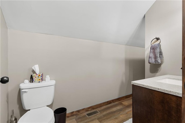 bathroom featuring hardwood / wood-style floors, vanity, and toilet