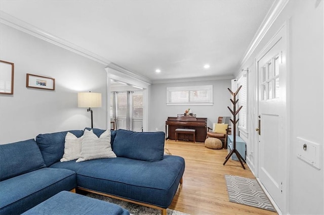 living room featuring light hardwood / wood-style flooring and ornamental molding