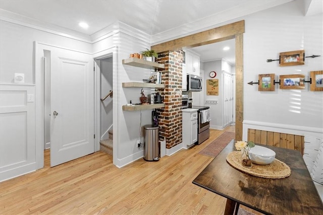 interior space with light hardwood / wood-style floors and ornamental molding