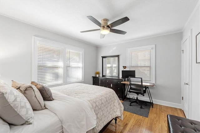 bedroom with ceiling fan, light wood-type flooring, ornamental molding, and multiple windows