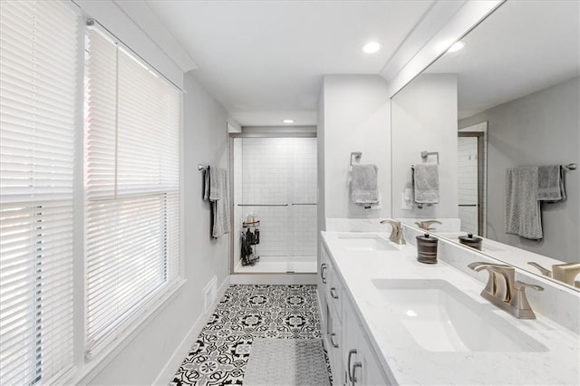 bathroom featuring a shower with door, vanity, and tile patterned flooring