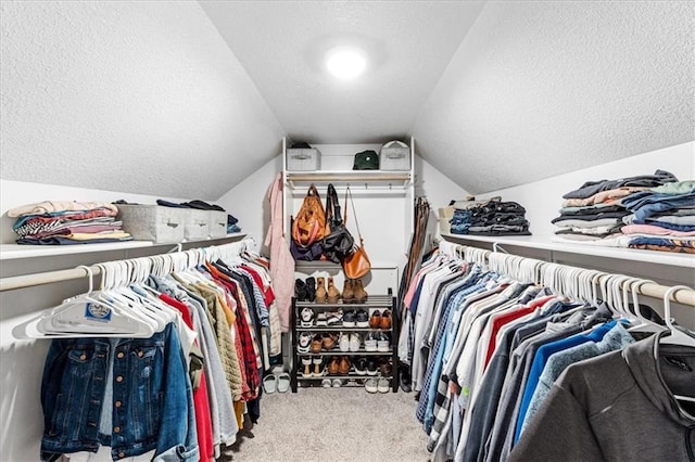 spacious closet with carpet floors and lofted ceiling